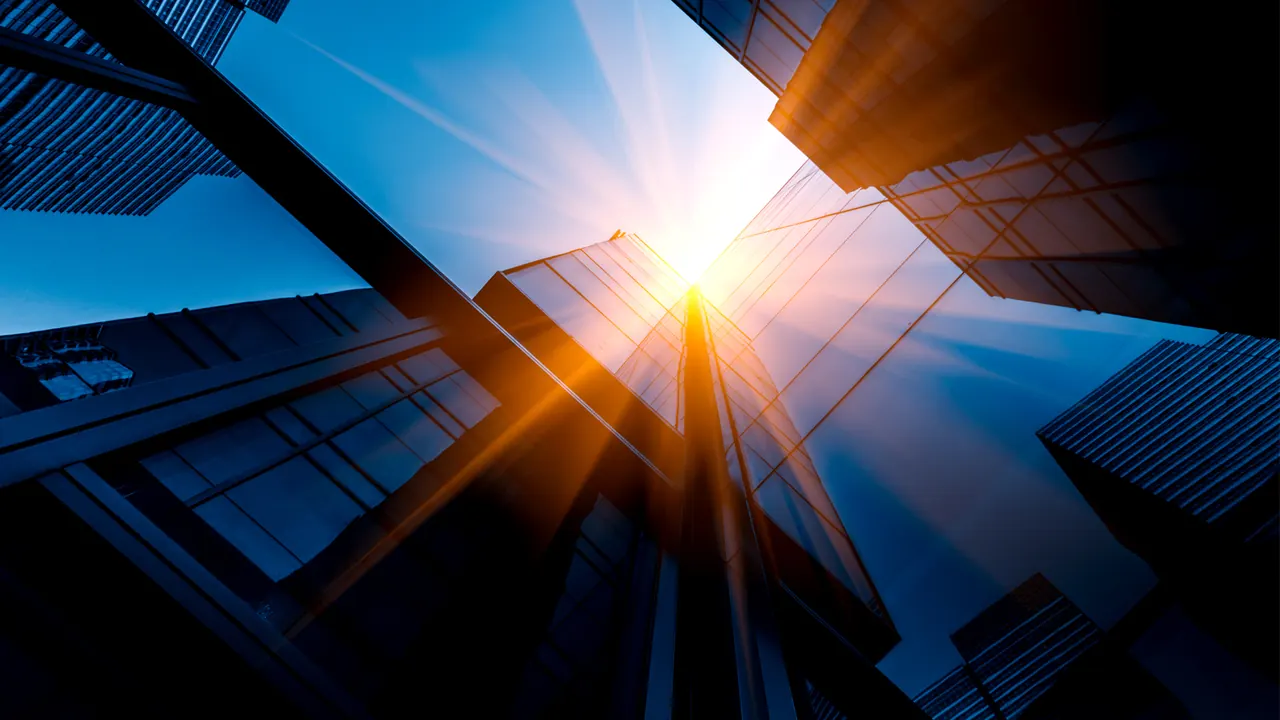 Looking up at glass office towers in Dubai